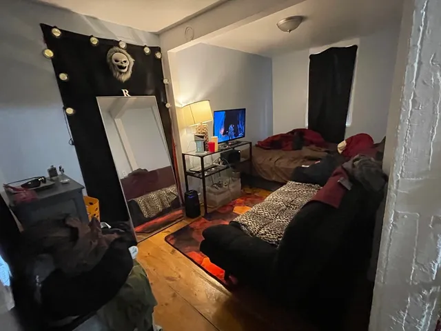 a living room with furniture and a mirror