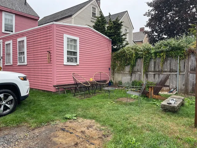 an empty room with wooden floor and window