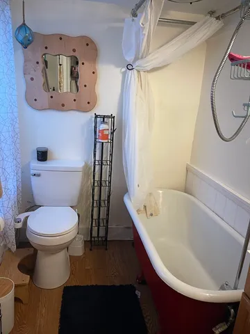 a bedroom with a bed and flat screen tv