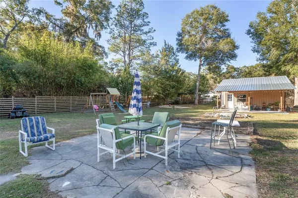 a view of a yard with a house in the background