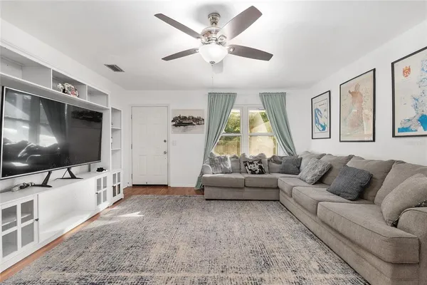 a living room with furniture and a flat screen tv
