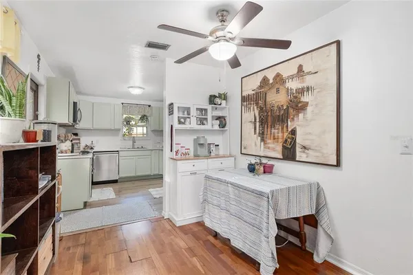 a kitchen with a white cabinets and window