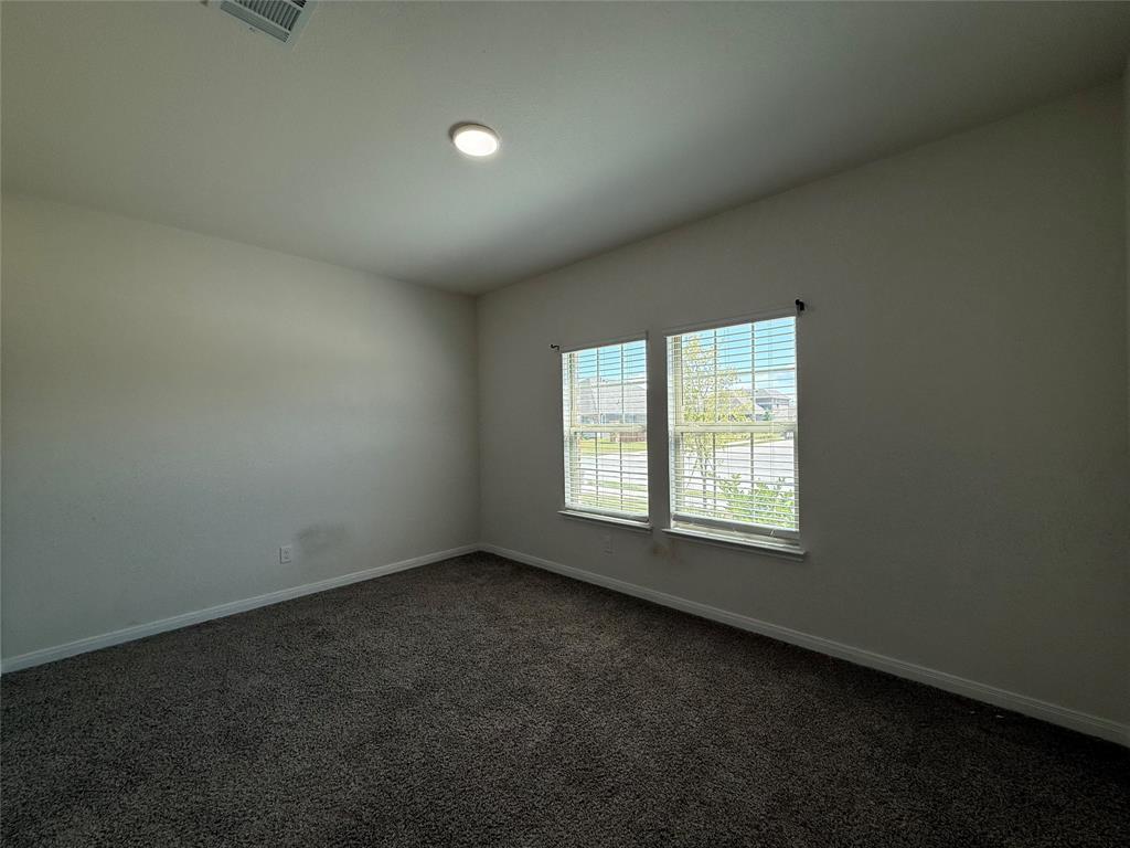 1400 Colonial Bluff Lane Princeton, TX 75407 - Photo 12 of 27 an empty room with a window