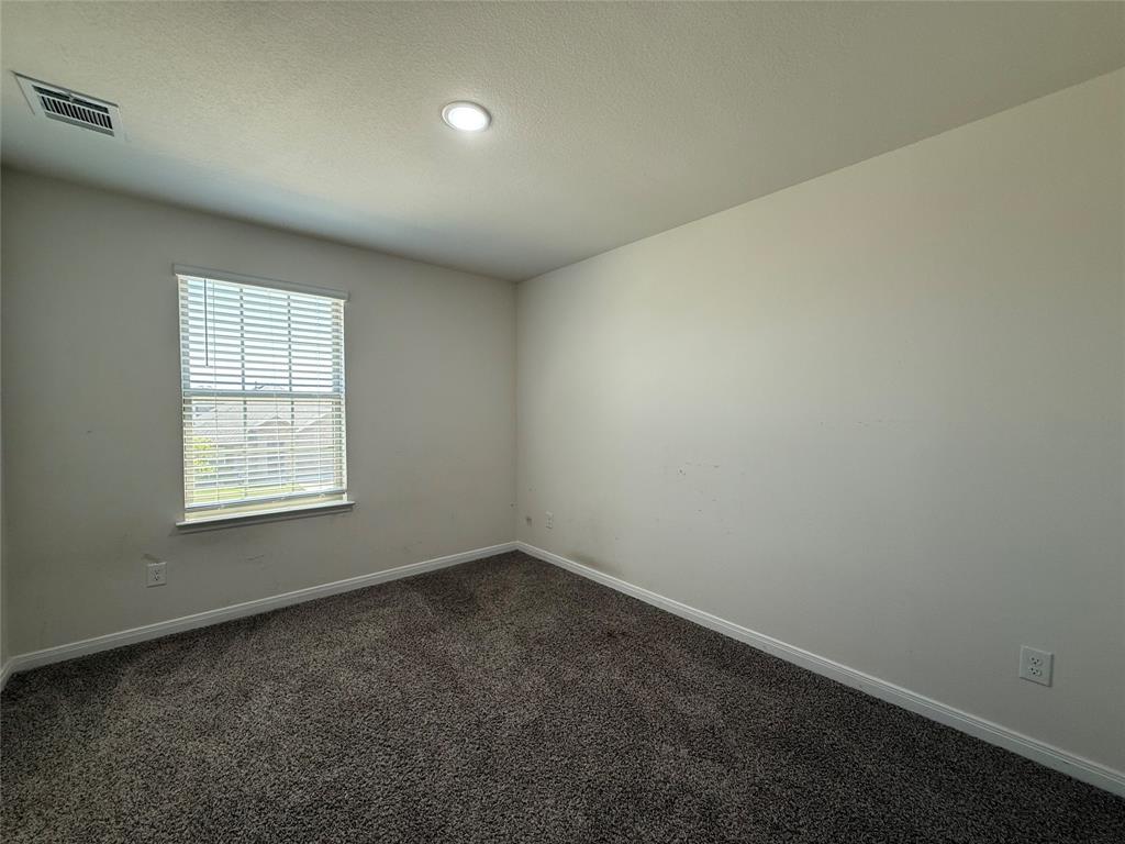 1400 Colonial Bluff Lane Princeton, TX 75407 - Photo 13 of 27 an empty room with a window