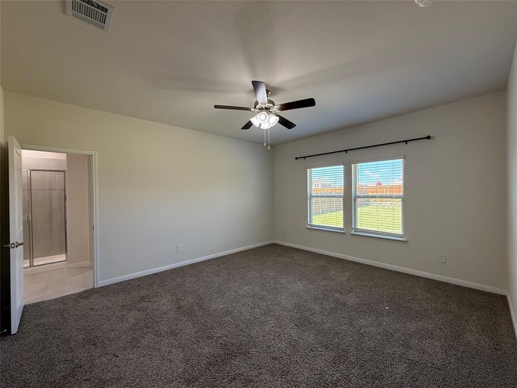 1400 Colonial Bluff Lane Princeton, TX 75407 - Photo 14 of 27 an empty room with windows and ceiling fan