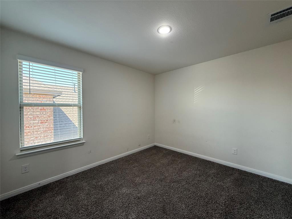 1400 Colonial Bluff Lane Princeton, TX 75407 - Photo 17 of 27 an empty room with a window