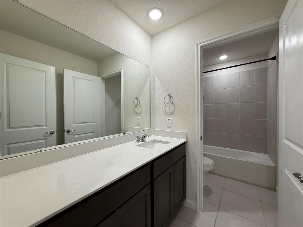 1400 Colonial Bluff Lane Princeton, TX 75407 - Photo 23 of 27 a bathroom with a sink a toilet and shower