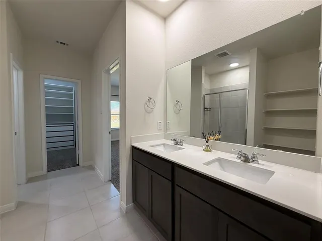a bathroom with a sink a double vanity and a mirror
