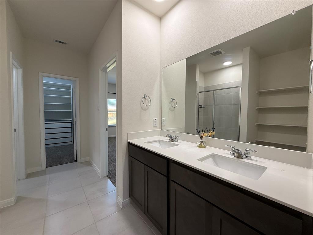 1400 Colonial Bluff Lane Princeton, TX 75407 - Photo 24 of 27 a bathroom with a sink a double vanity and a mirror