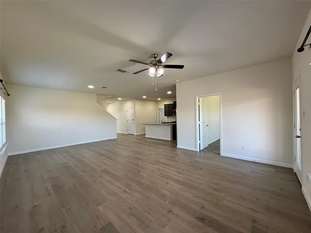 a view of an empty room with a kitchen