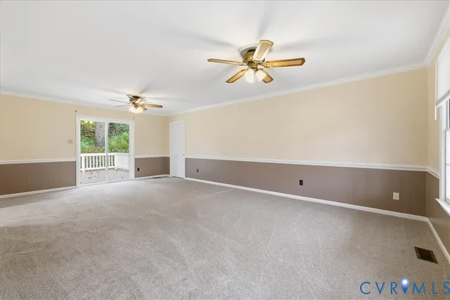 a view of a livingroom with a ceiling fan and window