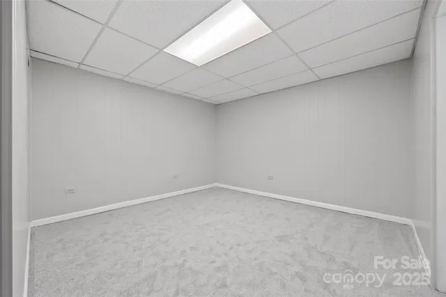 a view of empty room with cabinet and wooden floor