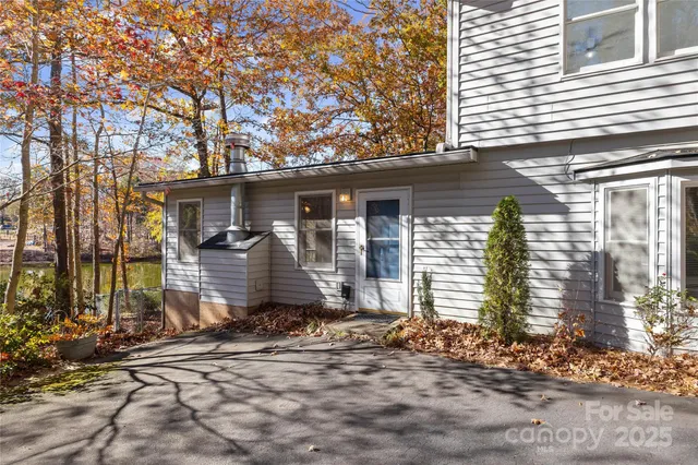 a front view of a house with a tree