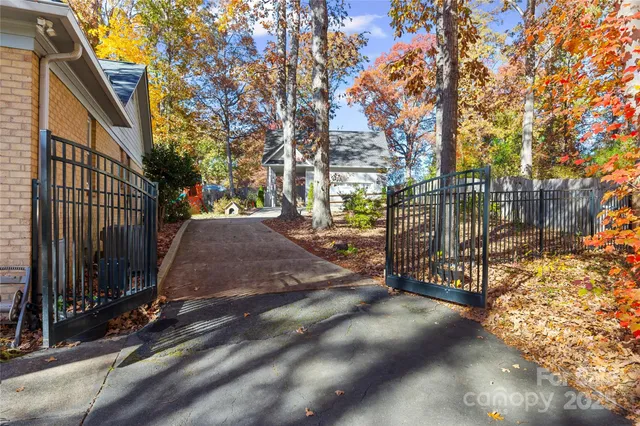 a backyard of a house with barbeque oven and outdoor seating
