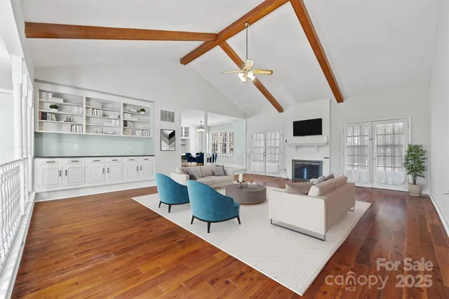 a view of empty room with wooden floor and fireplace