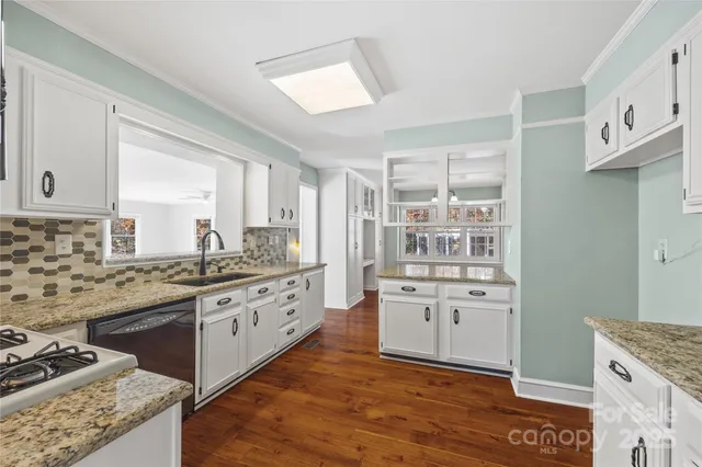 a living room with furniture ceiling fan and a window