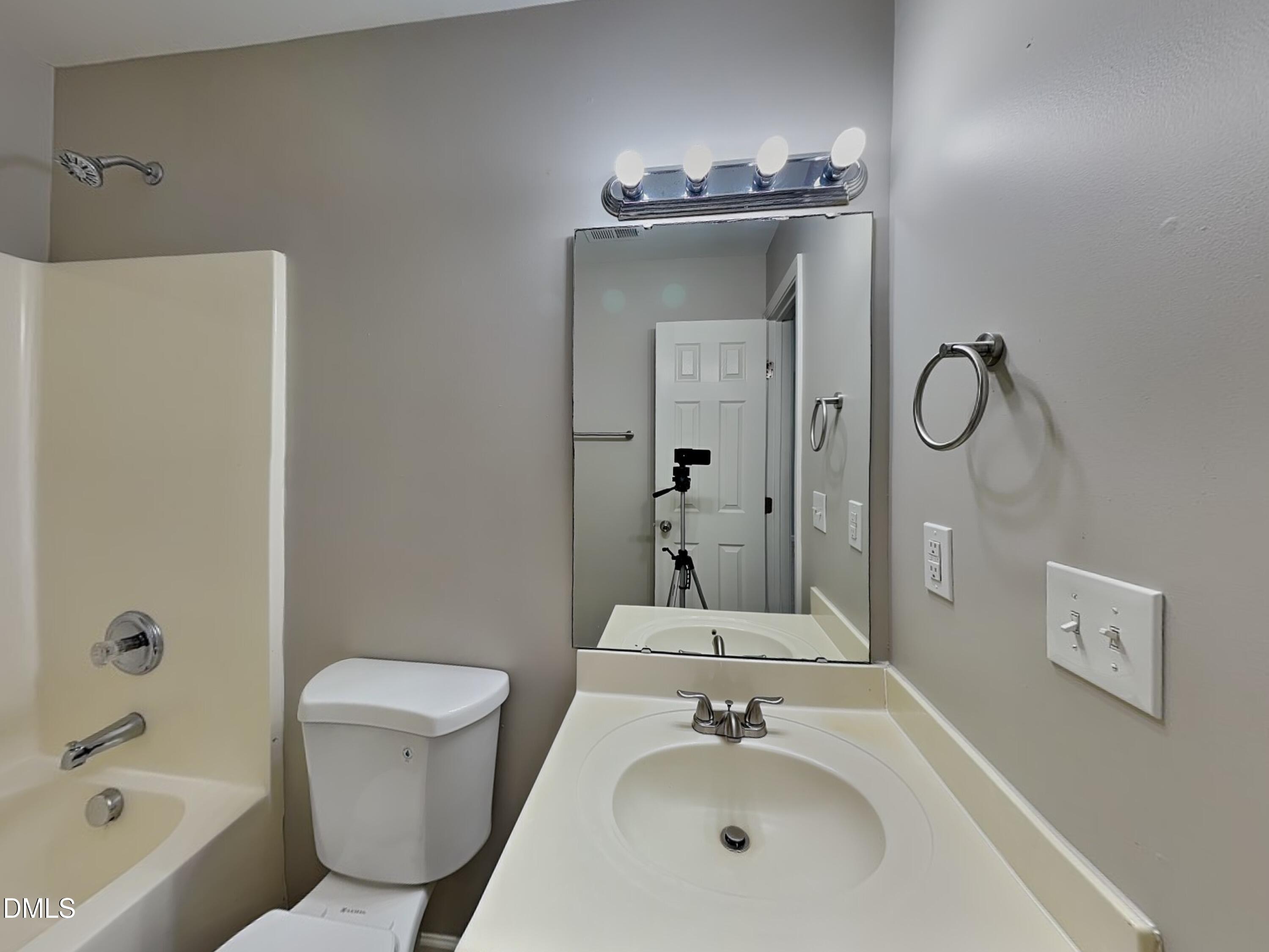 1609 Extine Lane Raleigh, NC 27610 - Photo 14 of 18 a bathroom with a sink a toilet and shower