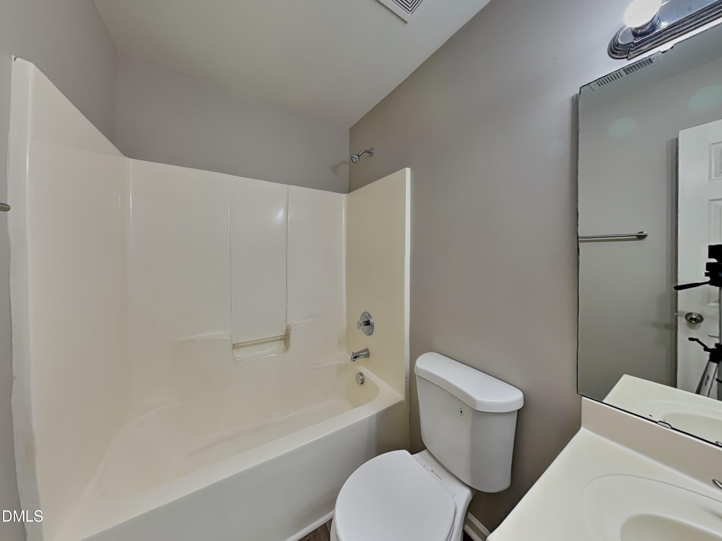 1609 Extine Lane Raleigh, NC 27610 - Photo 15 of 18 a white toilet sitting next to a bath tub
