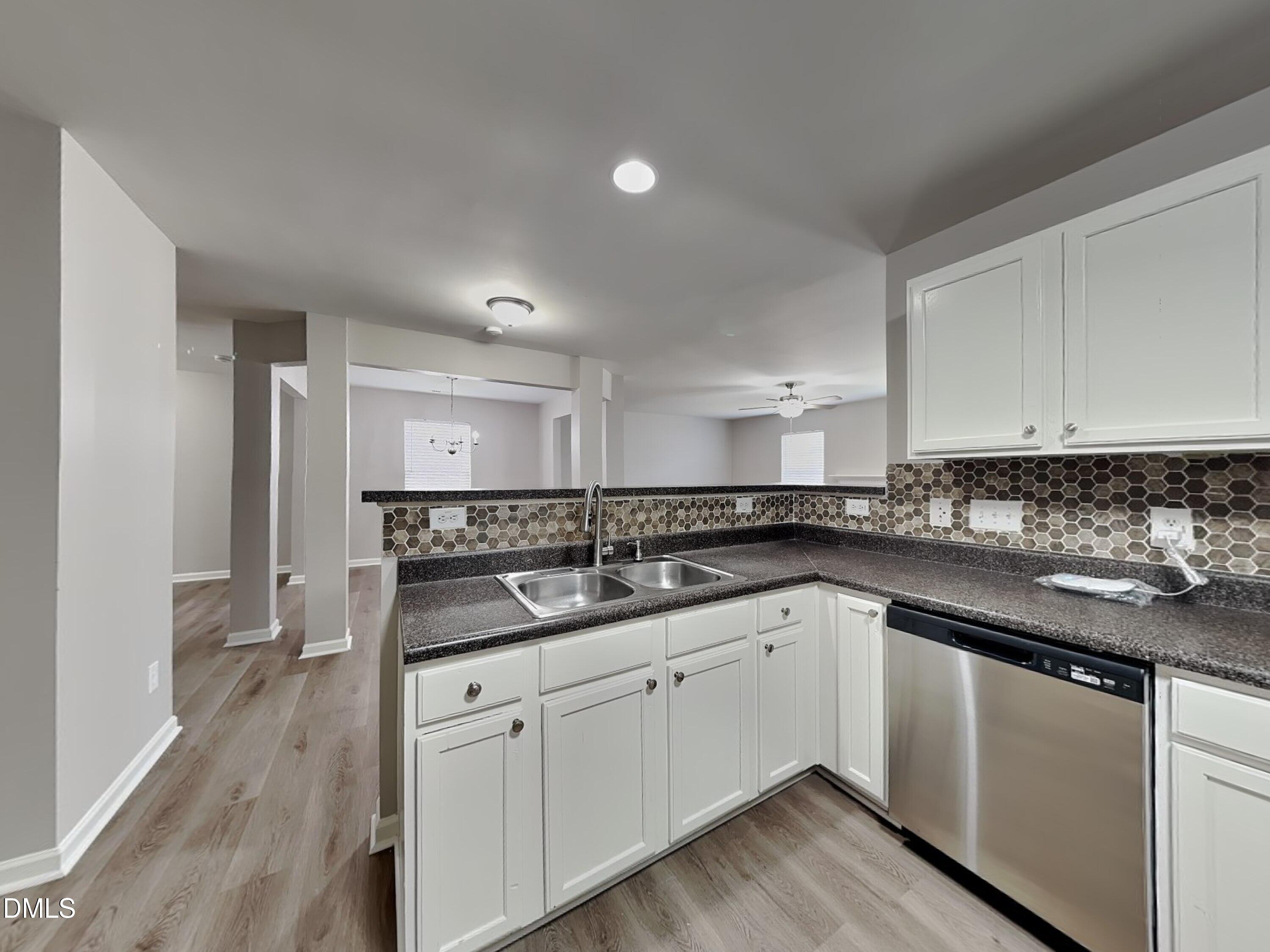 1609 Extine Lane Raleigh, NC 27610 - Photo 5 of 18 a kitchen with a sink stove and cabinets
