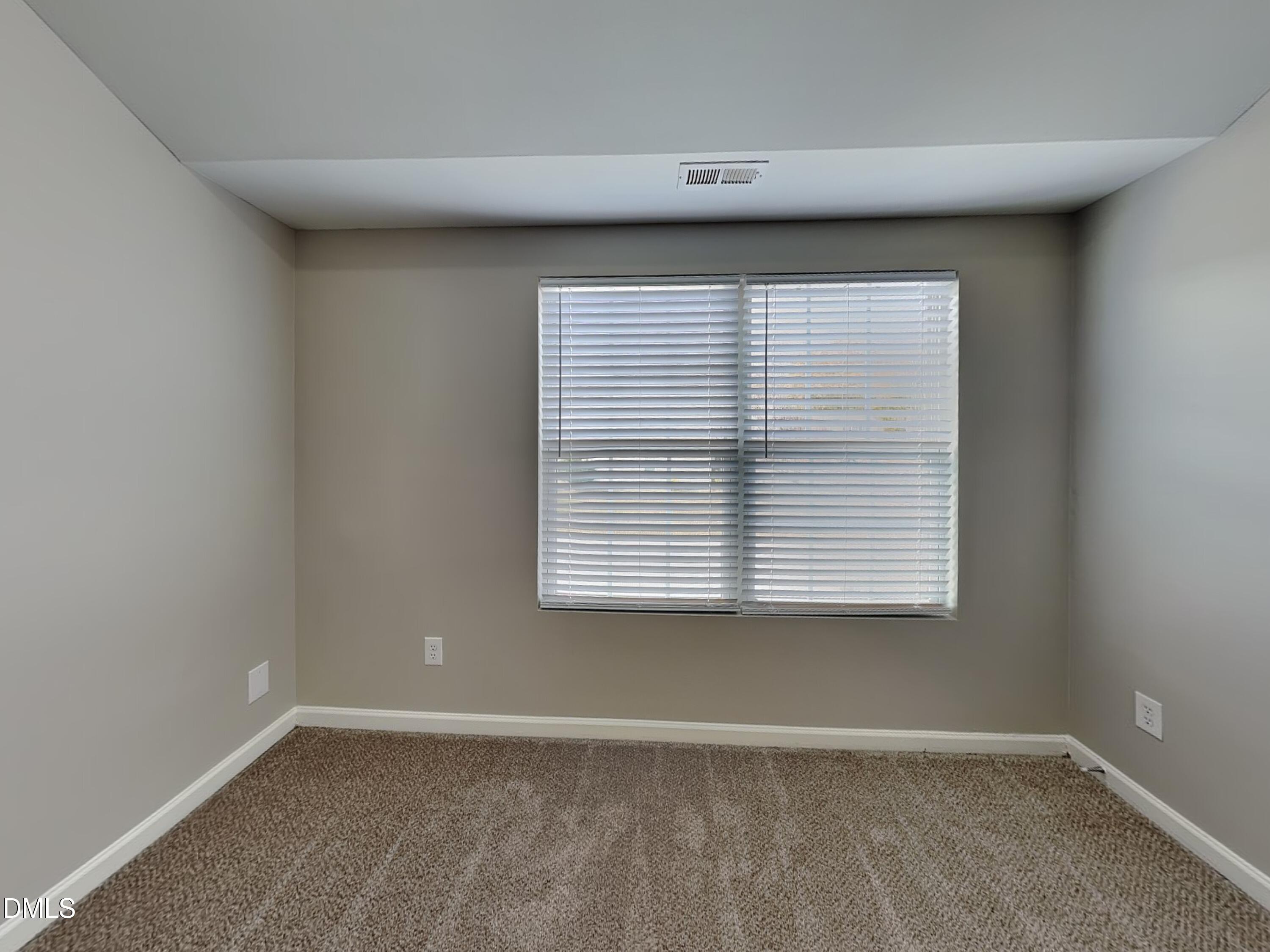 1609 Extine Lane Raleigh, NC 27610 - Photo 10 of 18 an empty room with a window