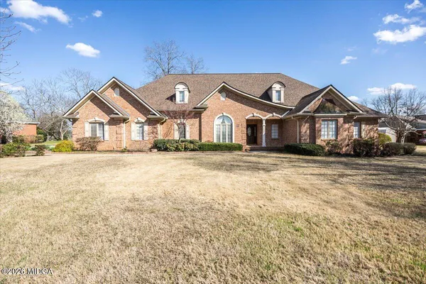 a front view of a house with a yard