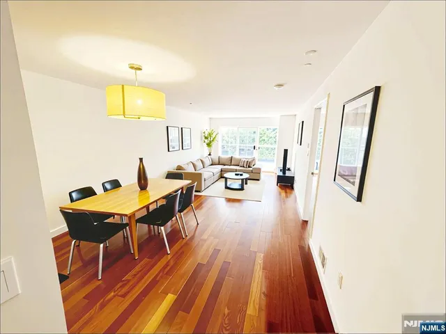 a living room with dining room and wooden floor