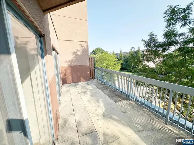 a view of a balcony with wooden floor and fence
