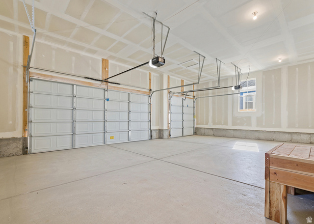 11214 South Easy Bee Road, Unit 270 South Jordan, UT 84009 - Photo 16 of 31 Spacious two-car garage featuring a concrete floor, automatic door openers, a window, and overhead lighting
