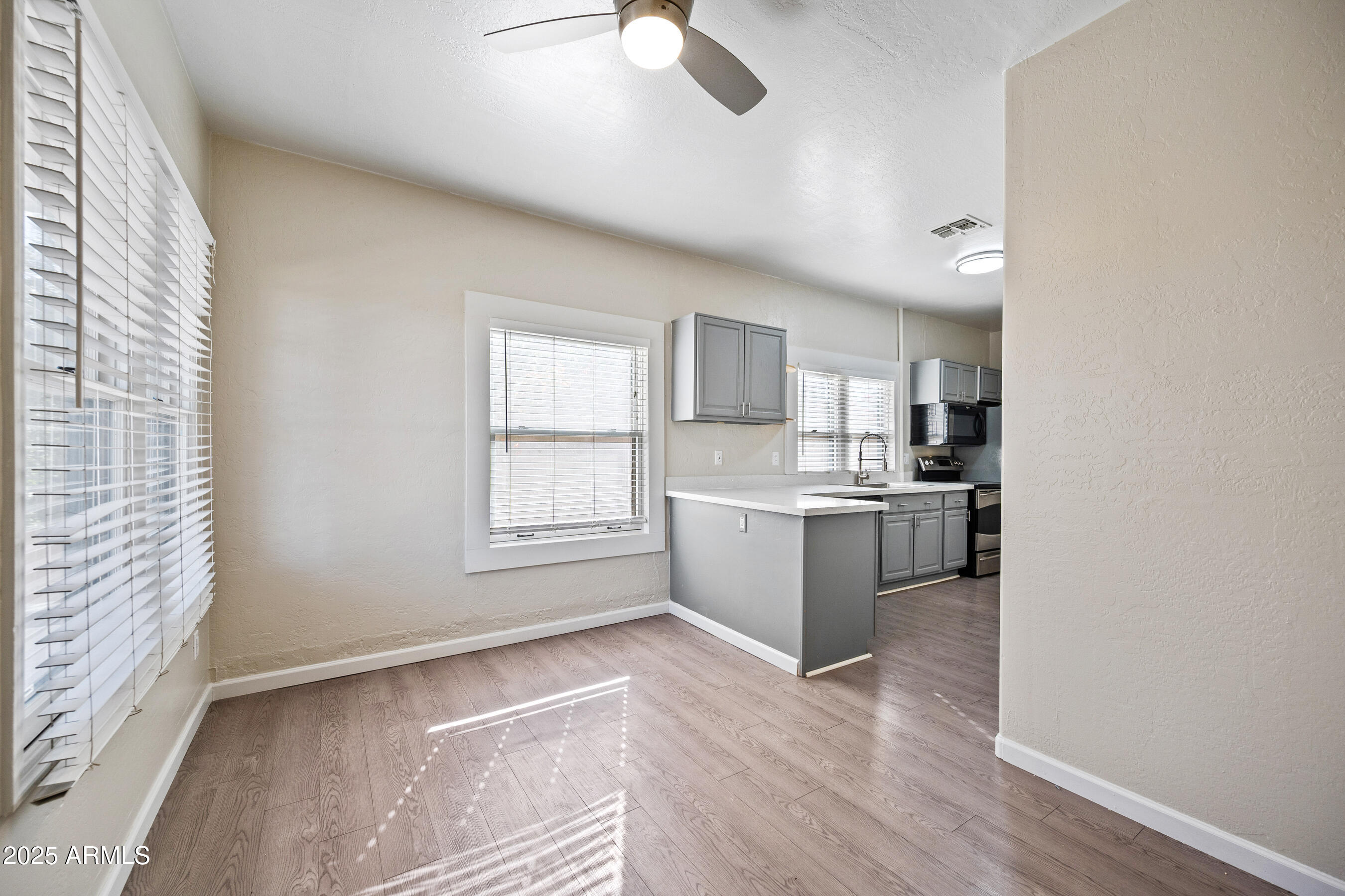 438 North 17th Avenue, Unit B Phoenix, AZ 85007 - Photo 5 of 19 a kitchen with a refrigerator and white cabinets