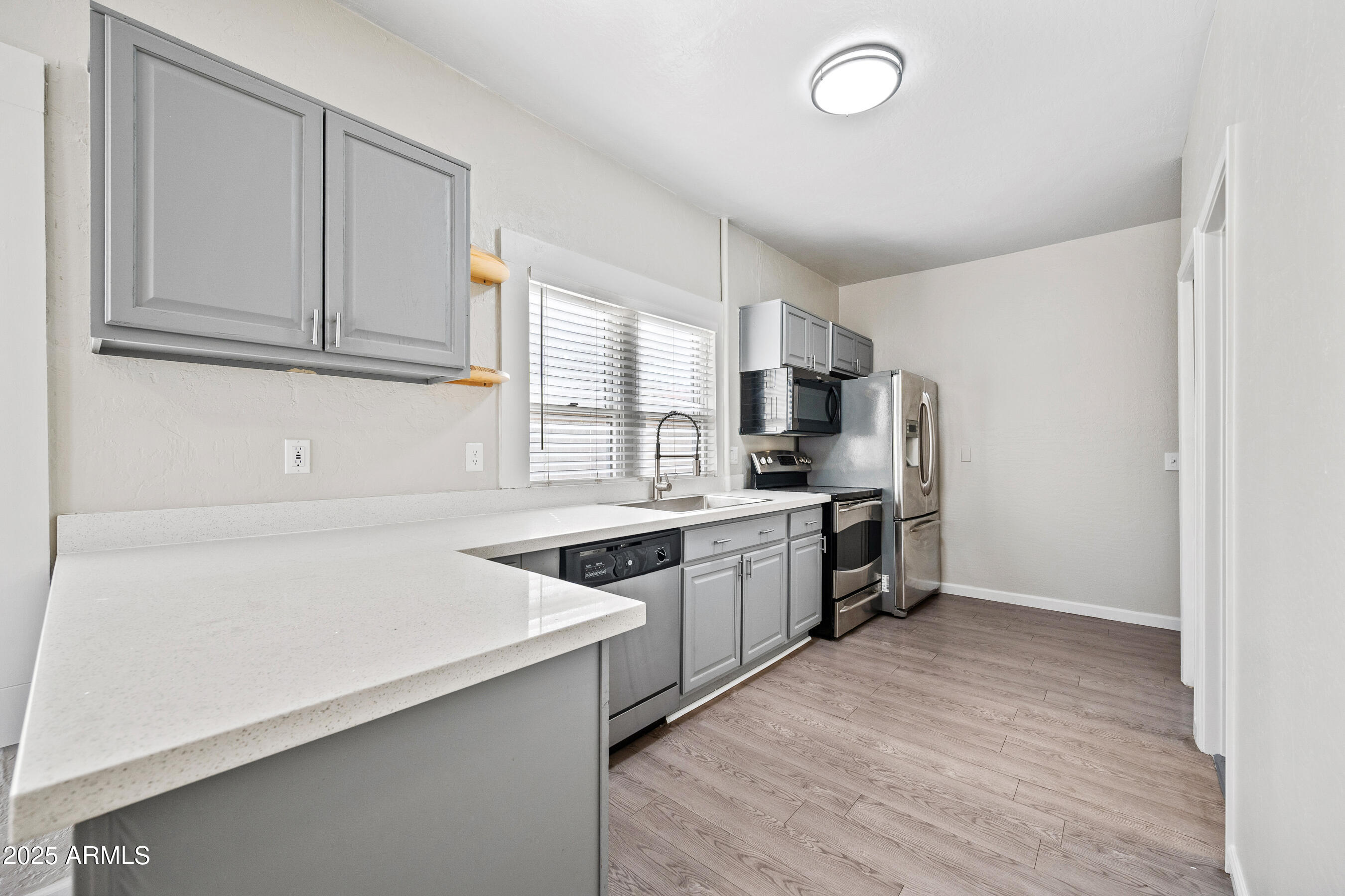 438 North 17th Avenue, Unit B Phoenix, AZ 85007 - Photo 7 of 19 a kitchen with granite countertop a sink stove and refrigerator