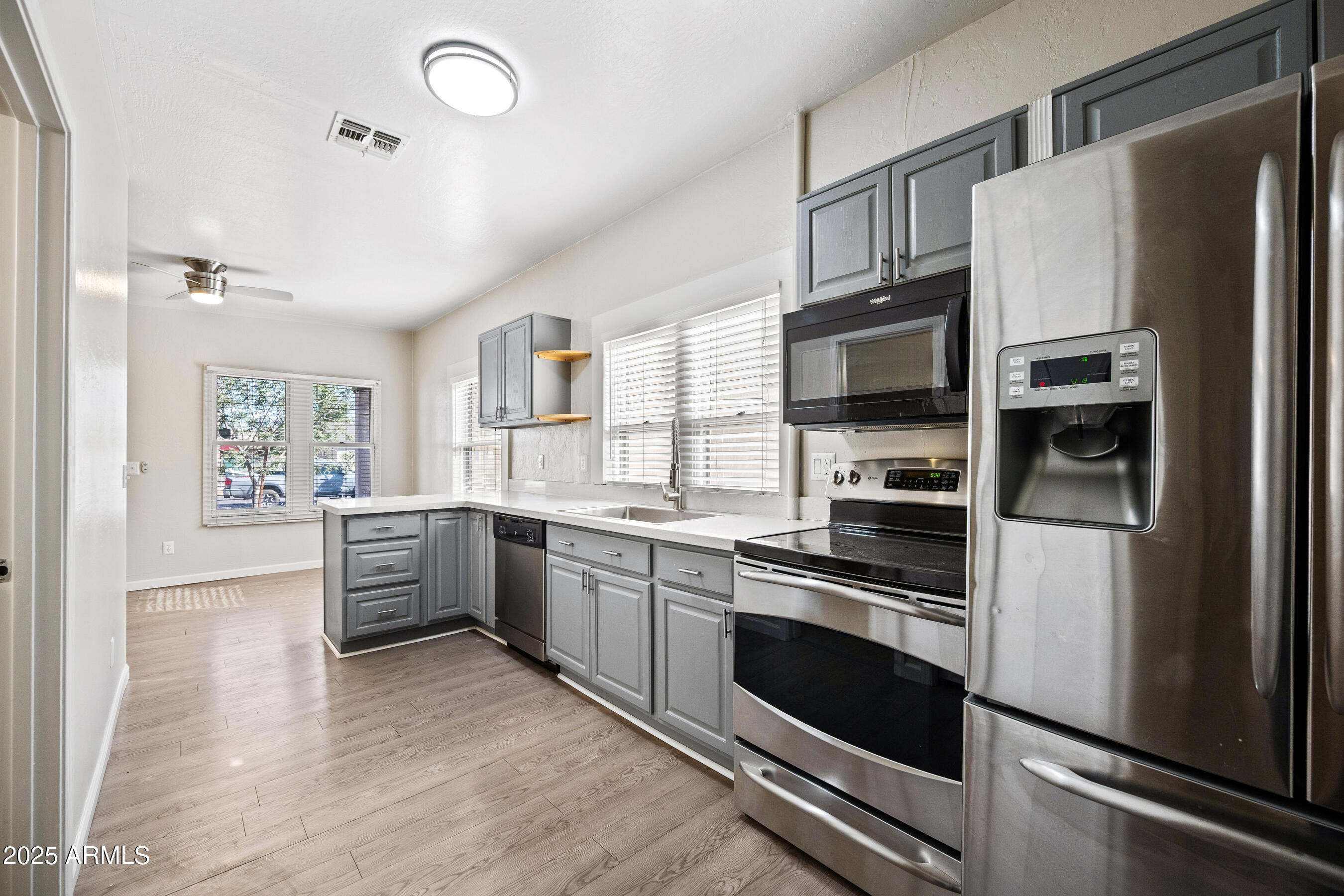 438 North 17th Avenue, Unit B Phoenix, AZ 85007 - Photo 8 of 19 a kitchen with stainless steel appliances kitchen island granite countertop a refrigerator stove and sink