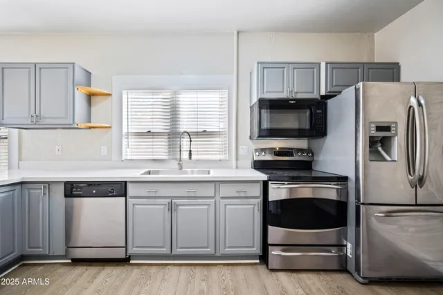 a kitchen with a refrigerator stove and microwave