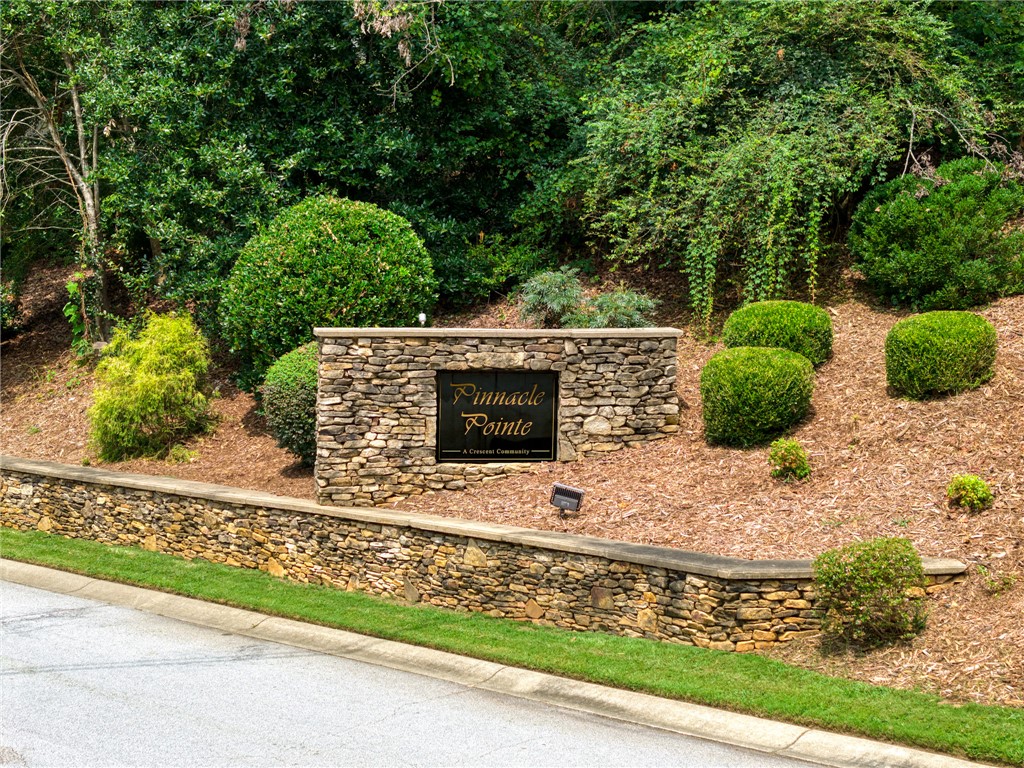 0 Pinnacle Pointe Drive Seneca, SC 29672 - Photo 7 of 7 This charming community entrance welcomes residents with natural stone and lush landscaping.