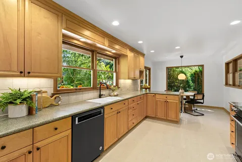 a kitchen with stainless steel appliances granite countertop sink stove and cabinets