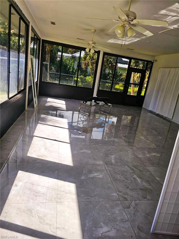 3770 25th Avenue Southwest Naples, FL 34117 - Photo 11 of 15 a living room with furniture and a large window