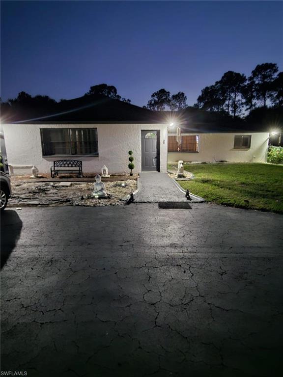 3770 25th Avenue Southwest Naples, FL 34117 - Photo 3 of 15 a front view of a house with a garden and a fire pit