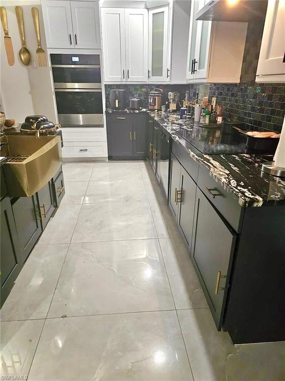 3770 25th Avenue Southwest Naples, FL 34117 - Photo 6 of 15 a kitchen with stainless steel appliances granite countertop a stove a sink and a microwave