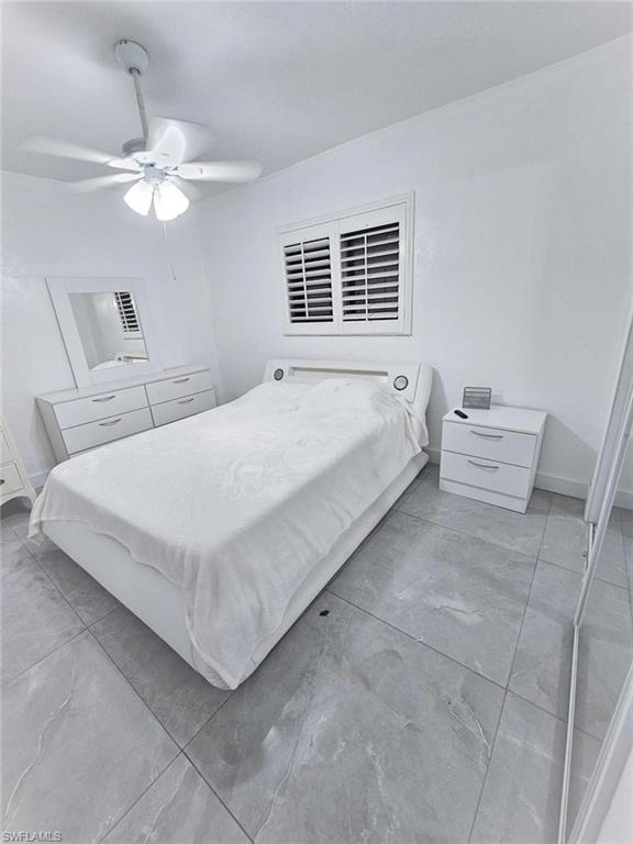 3770 25th Avenue Southwest Naples, FL 34117 - Photo 9 of 15 a bed room with a bed and a chandelier