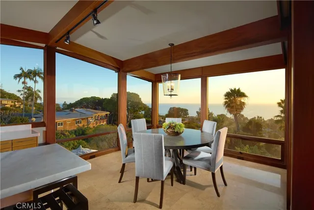 a dining room with furniture and a floor to ceiling window