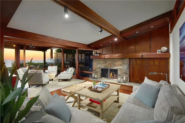 a bedroom with furniture and large windows