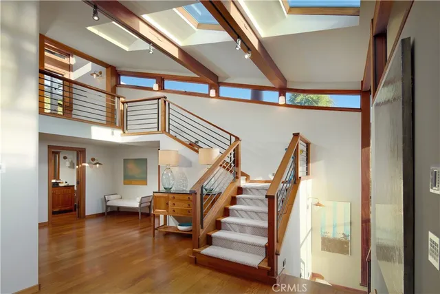 a view of entryway and hall with wooden floor