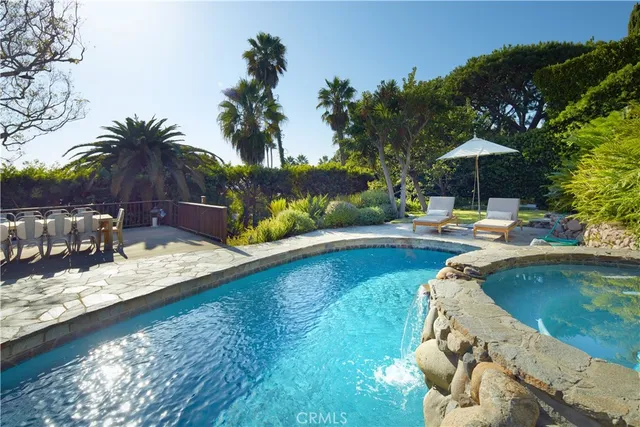 a view of a swimming pool with a patio and a garden