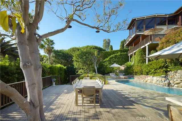 a view of a patio with table and chairs and potted plants