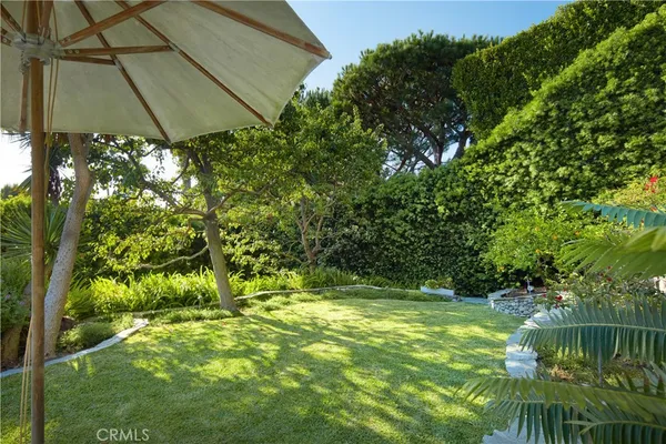 a view of deck with furniture and umbrella