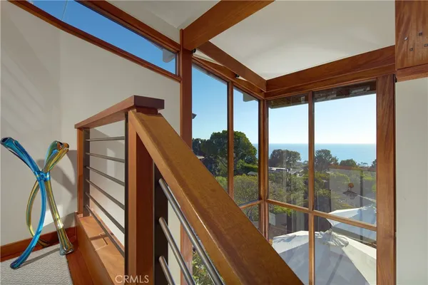a dining room with furniture and a floor to ceiling window