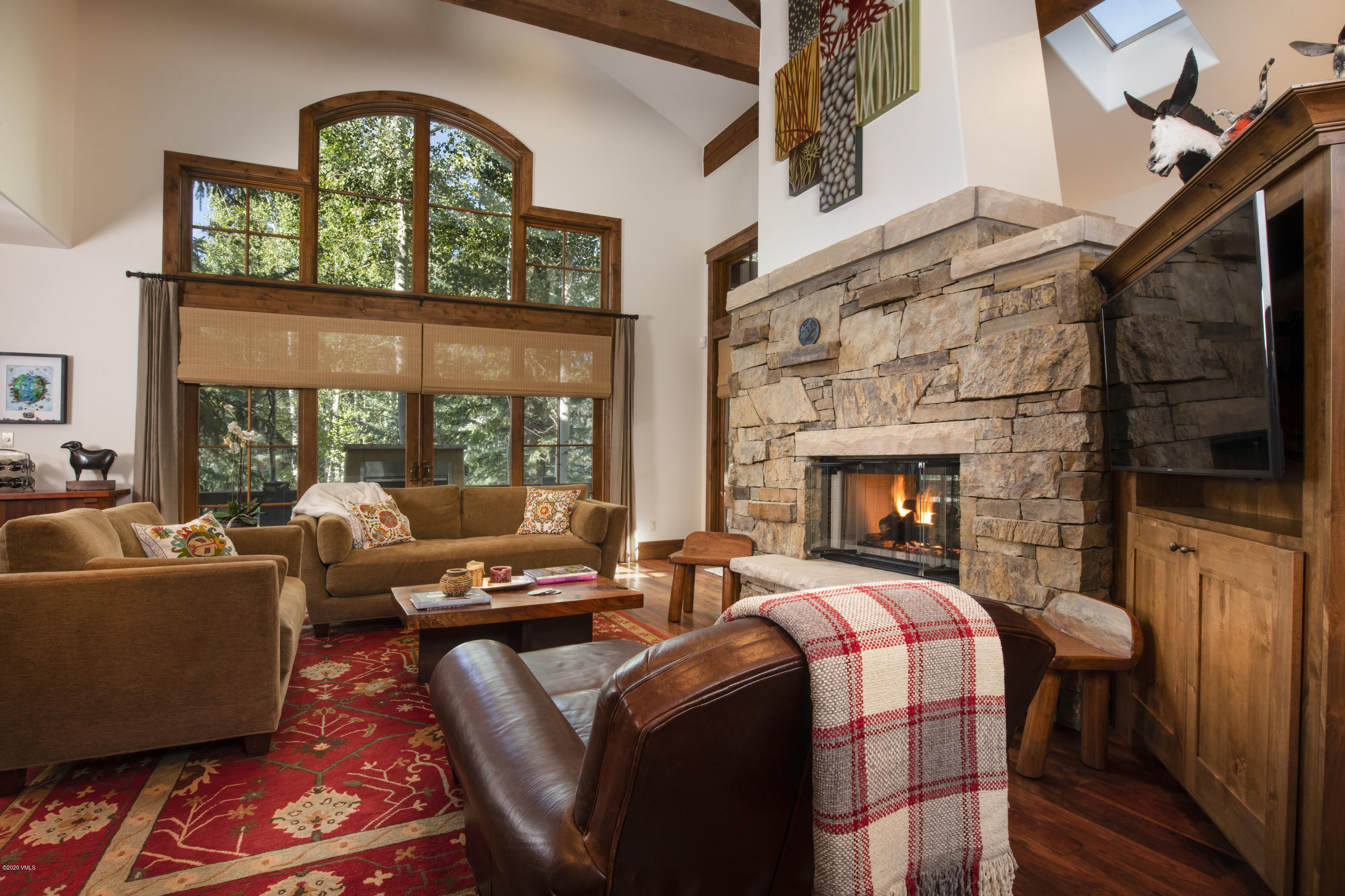 a living room with fireplace furniture and a flat screen tv