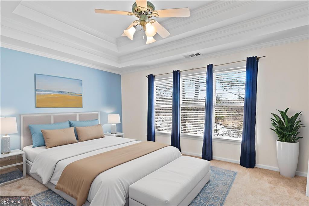 325 Morning Mist Walk Suwanee, GA 30024 - Photo 17 of 67 a bedroom with a large bed and a chandelier