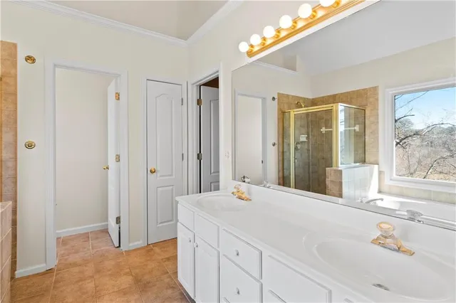 an empty room with chandelier fan and windows