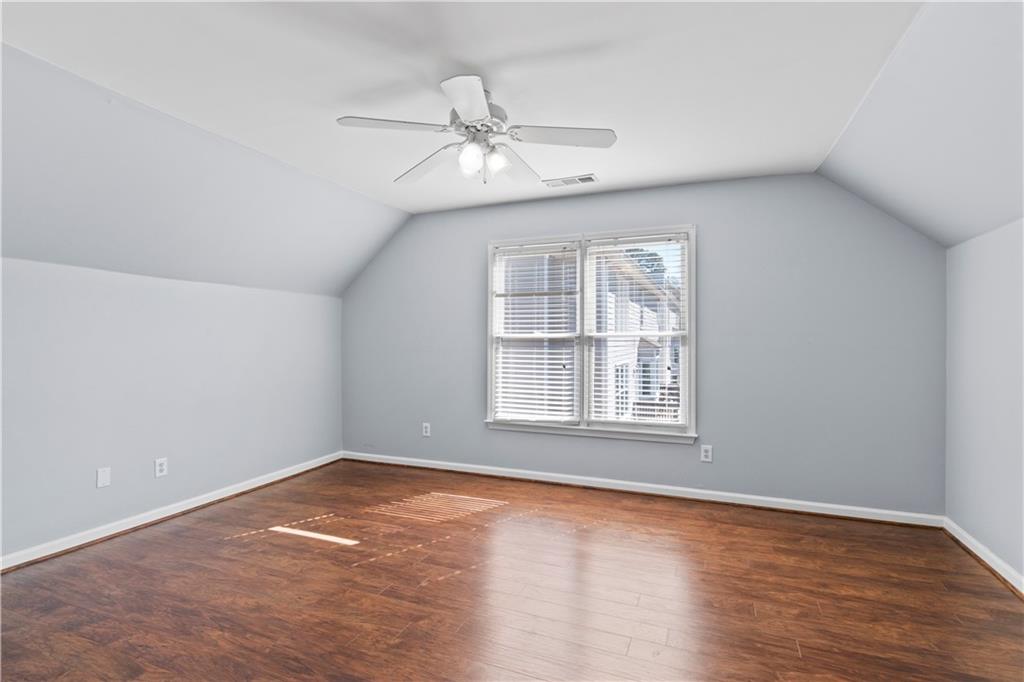 325 Morning Mist Walk Suwanee, GA 30024 - Photo 30 of 67 an empty room with wooden floor fan and windows
