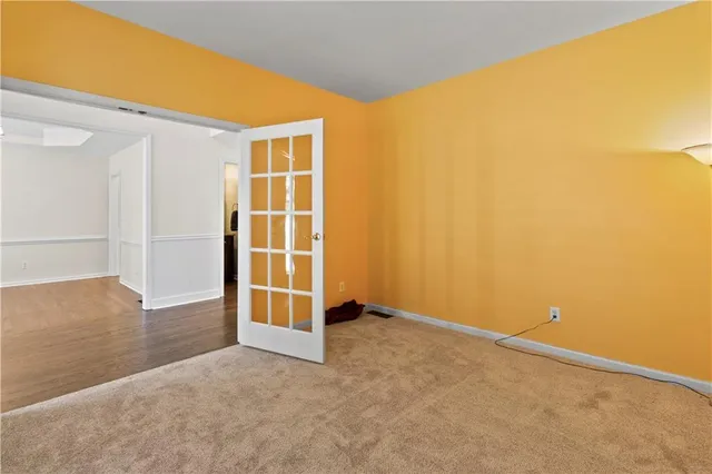 an empty room with a chandelier fan
